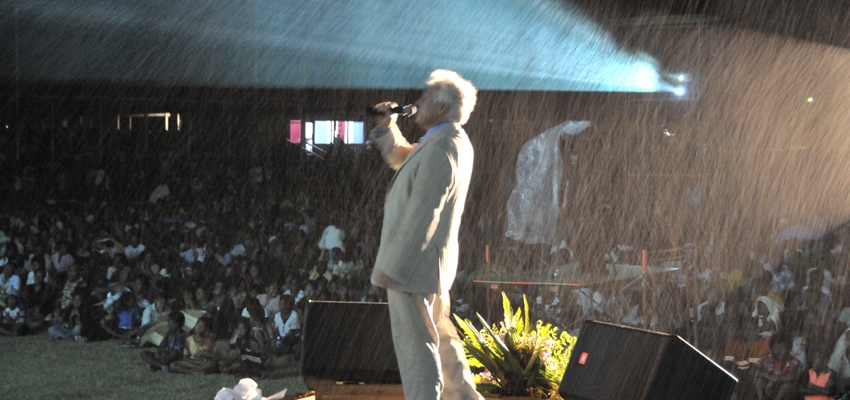 Pastor John Carter preaching in the rain.